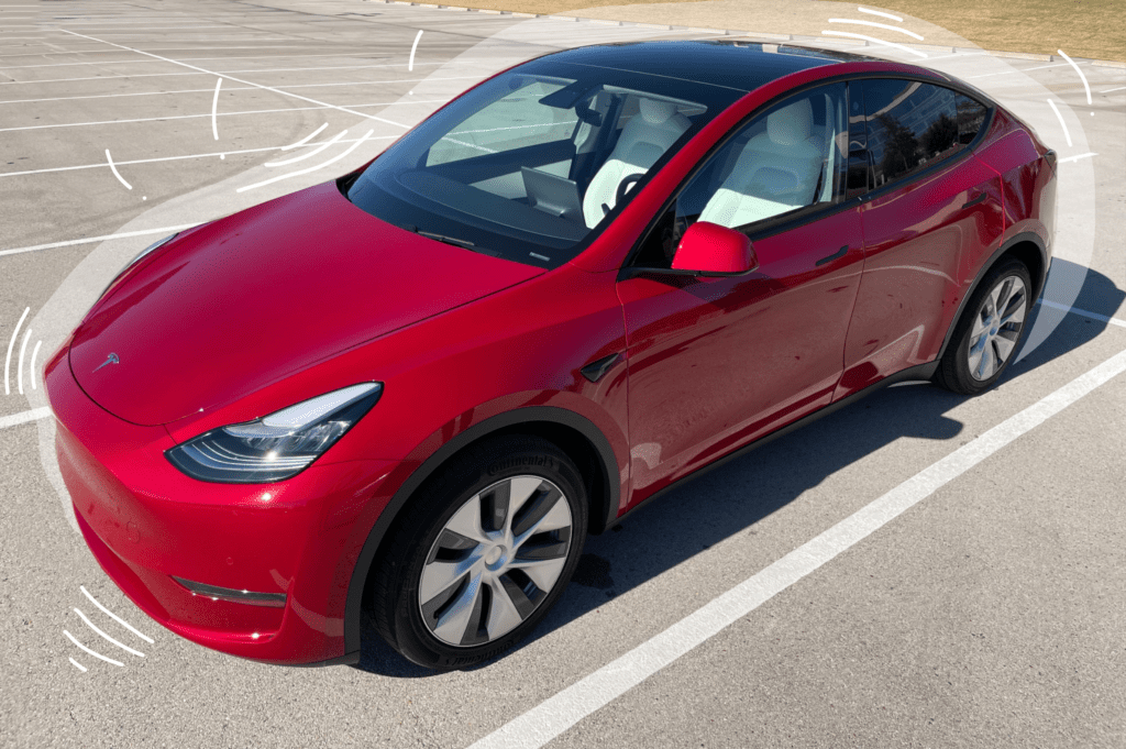 Exterior shot of a red color Tesla Model Y car in a parking lot