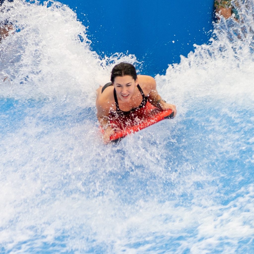 woman on the Flowrider boogie board