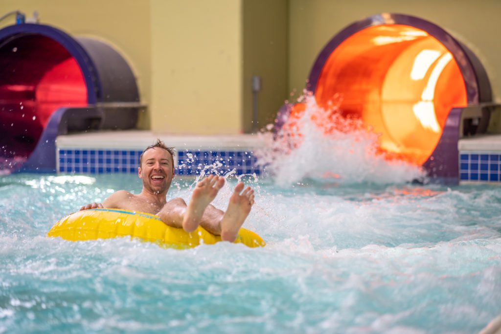 man in a tube and water slide