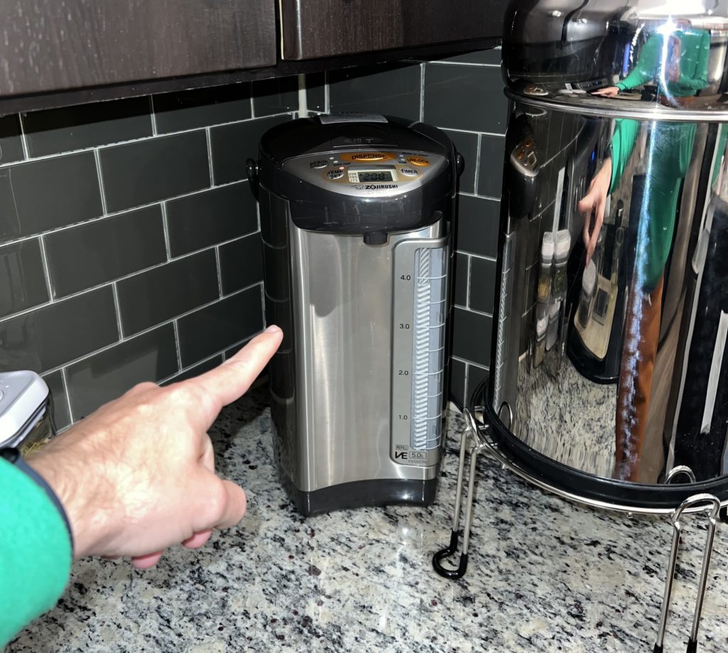 hand pointing to the water boiler