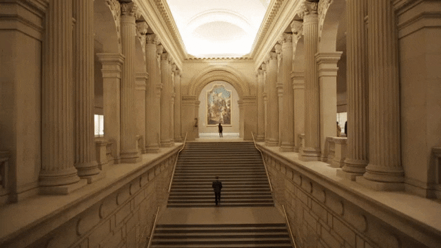 animated GIF of a man going up the grand staircase
