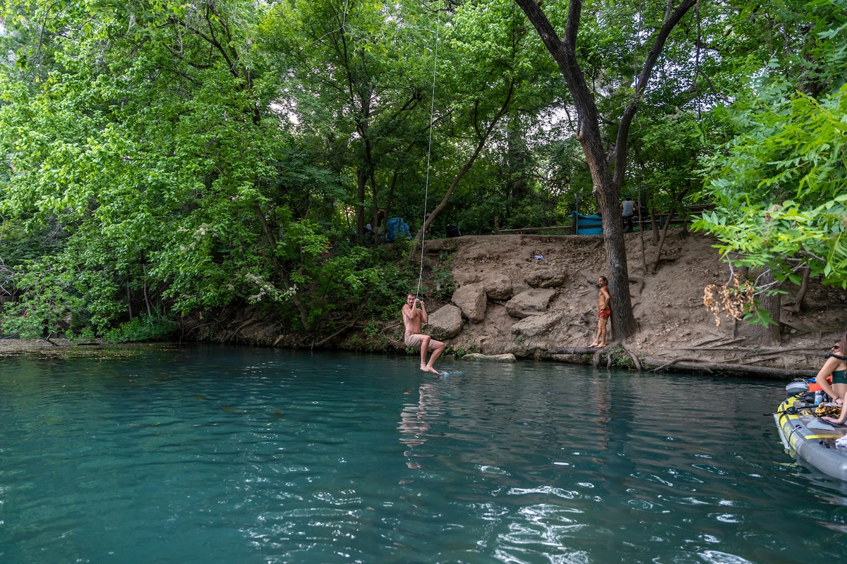 My friend swinging off the rope swing. The best place to stand for this swing is on top of one of those upper rocks, but be careful!