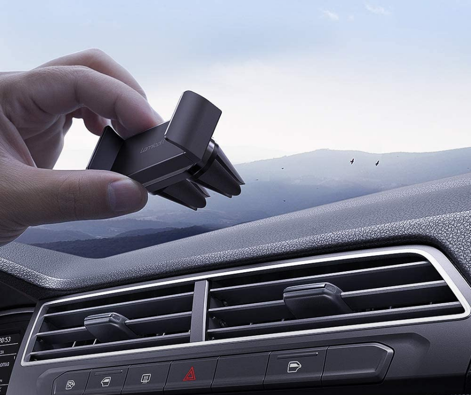 hand holding a small car phone mount