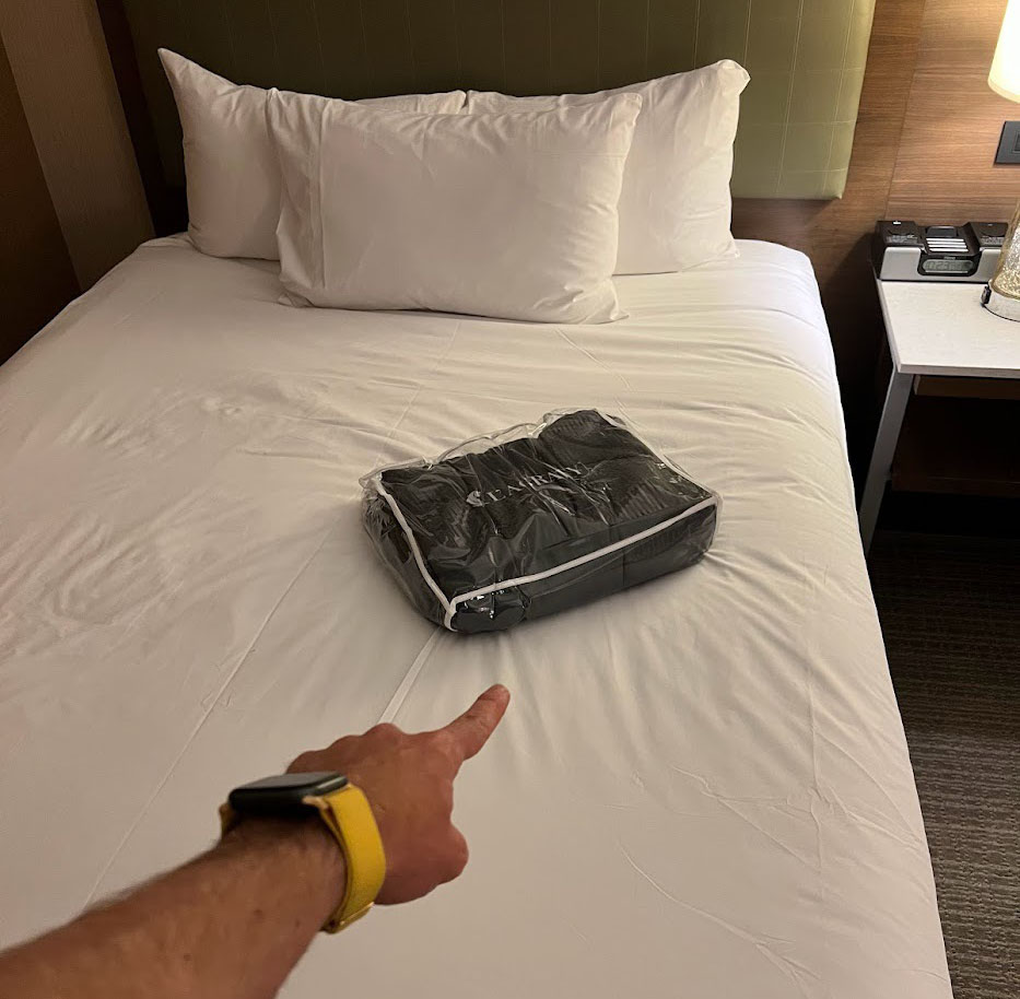 hand pointing to the weighted blanked on top of the bed