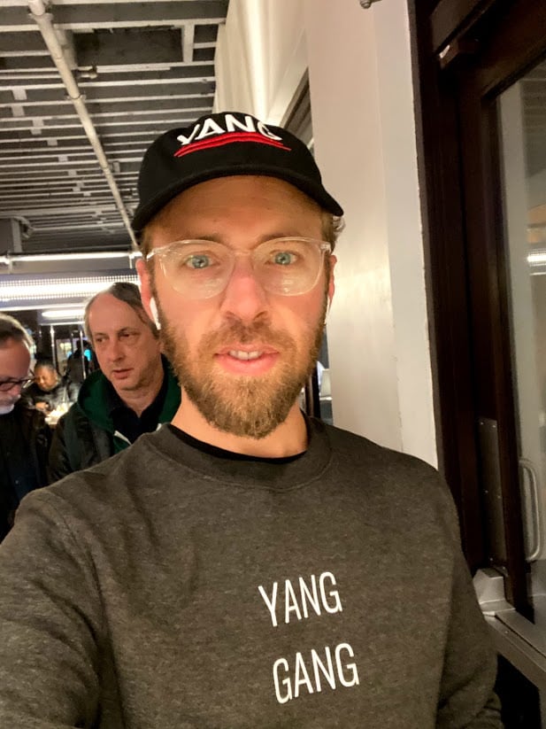 Me wearing a YANG hat and sweatshirt