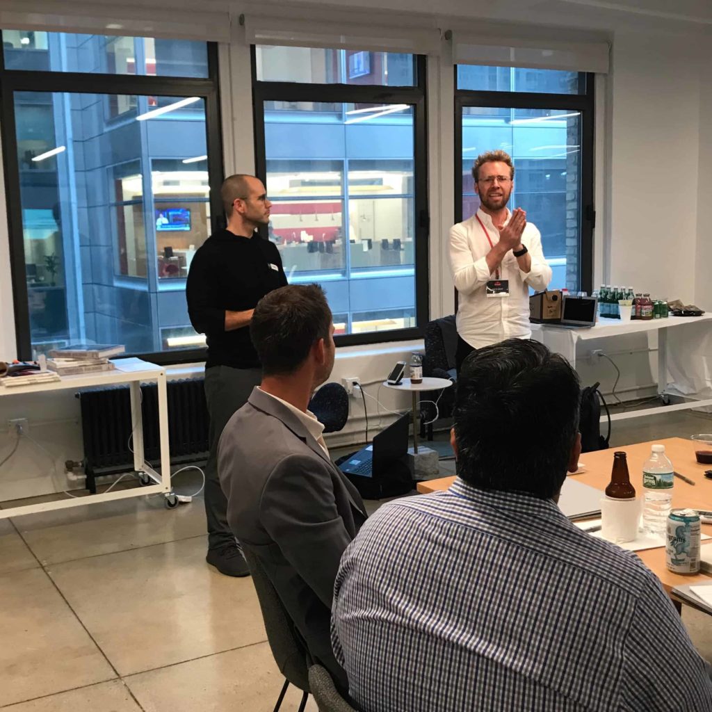 Two people in front of a crowd at Skubana mastermind for Amazon sellers and brands