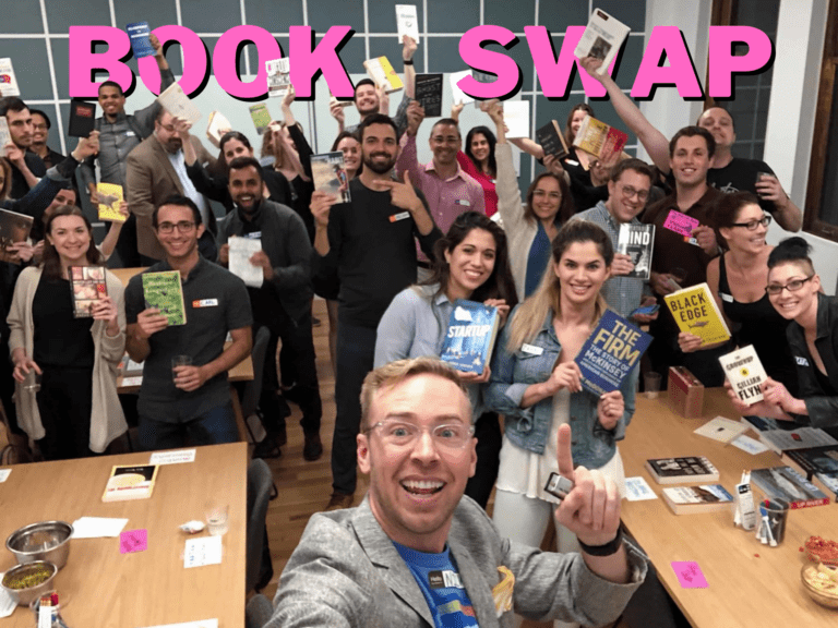Group of people holding a book with the title book swap on top