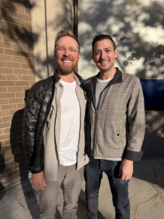 Two men smiling