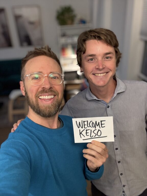 Two men smiling