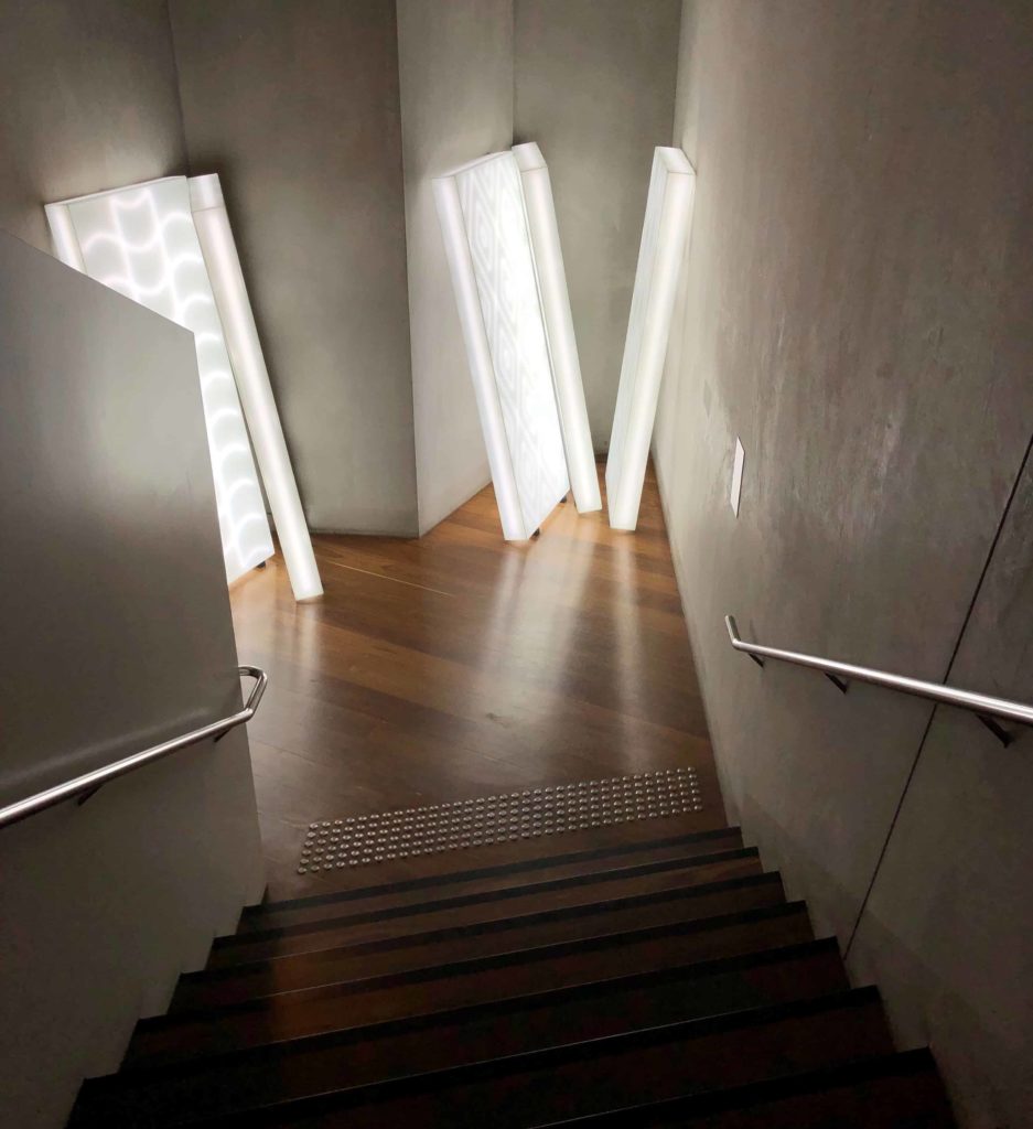 Light sculpture that’s bright white against concrete walls