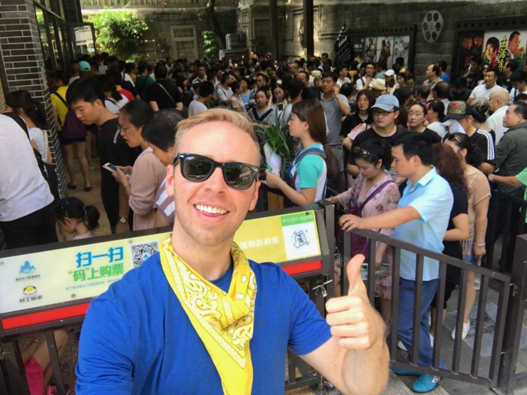 Attractive gentleman with friendly domestic tourists in background