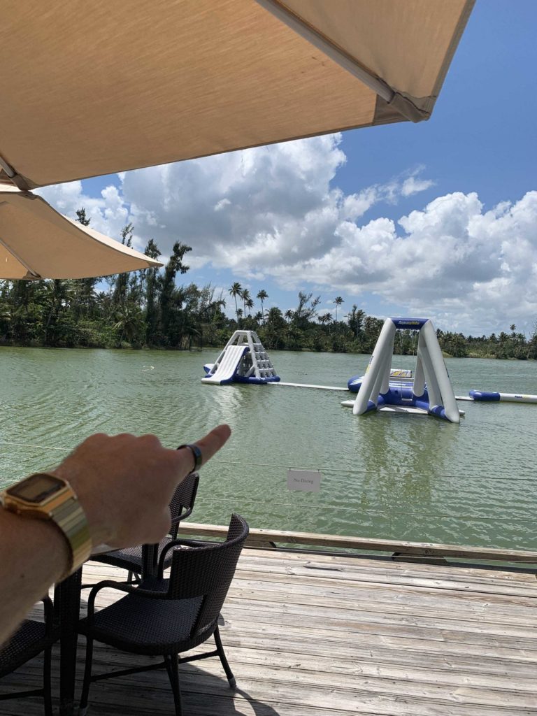 Floating slides on a small lake, hand pointing towards it