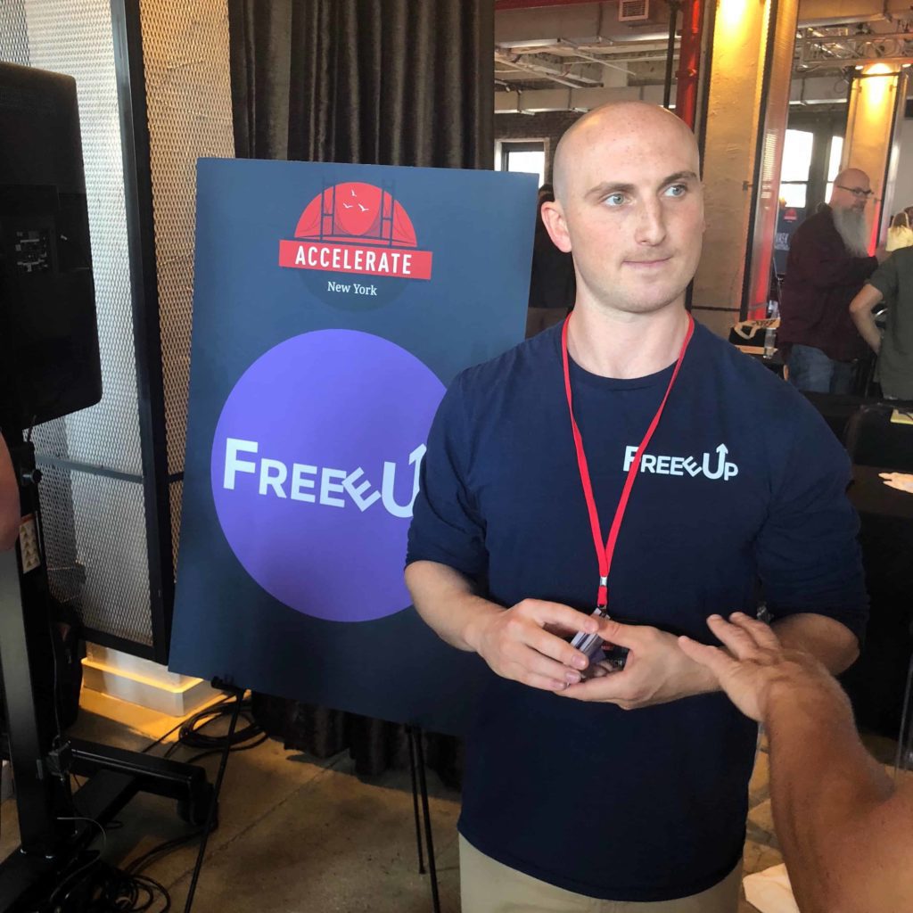 Man standing in front of sign at Amazon brands conference Skubana