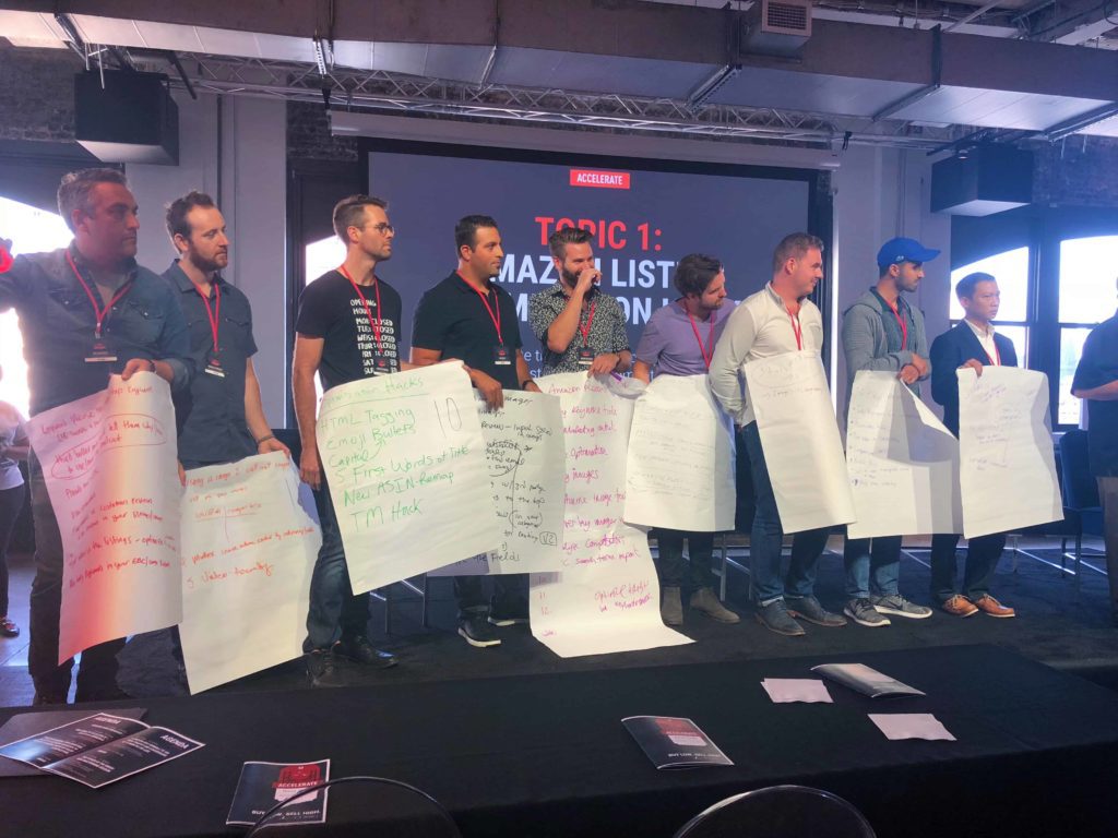 People on stage with papers