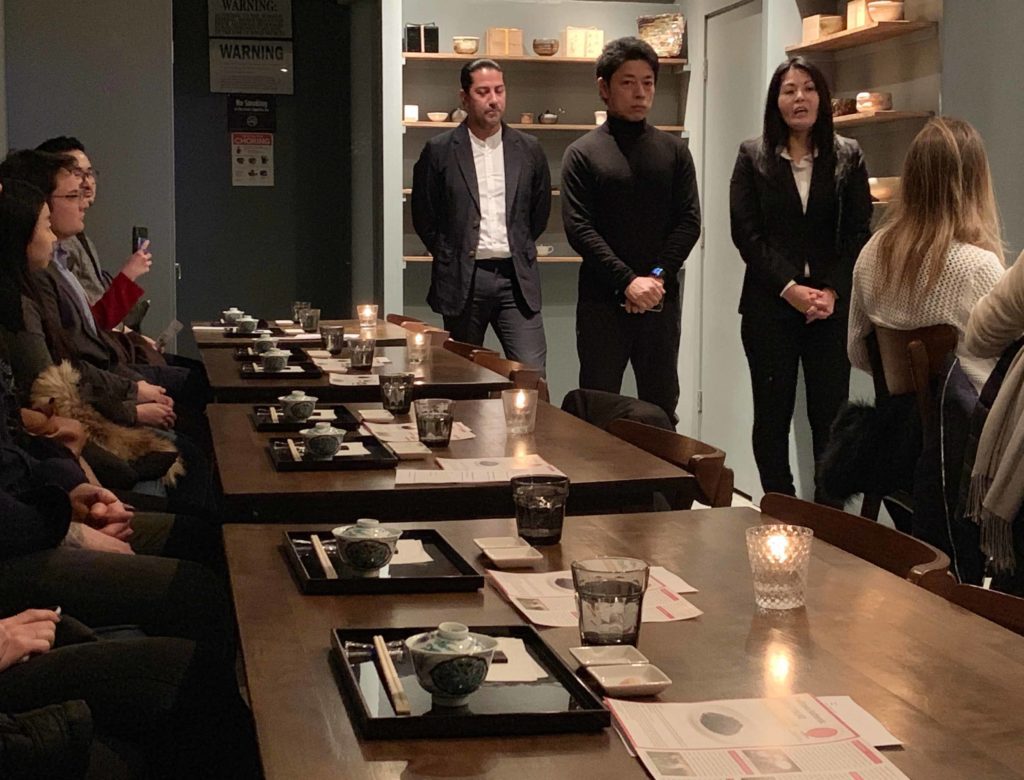 Table settings like in a restaurant. Three people standing in the back