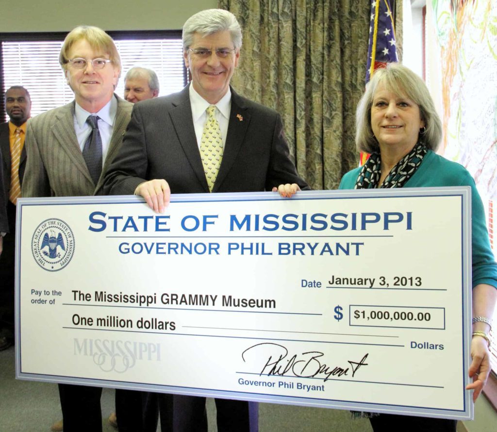 Holding a check for a museum