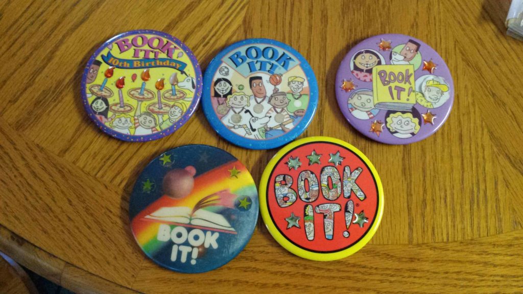 Five buttons from the Book It! program of various vintages