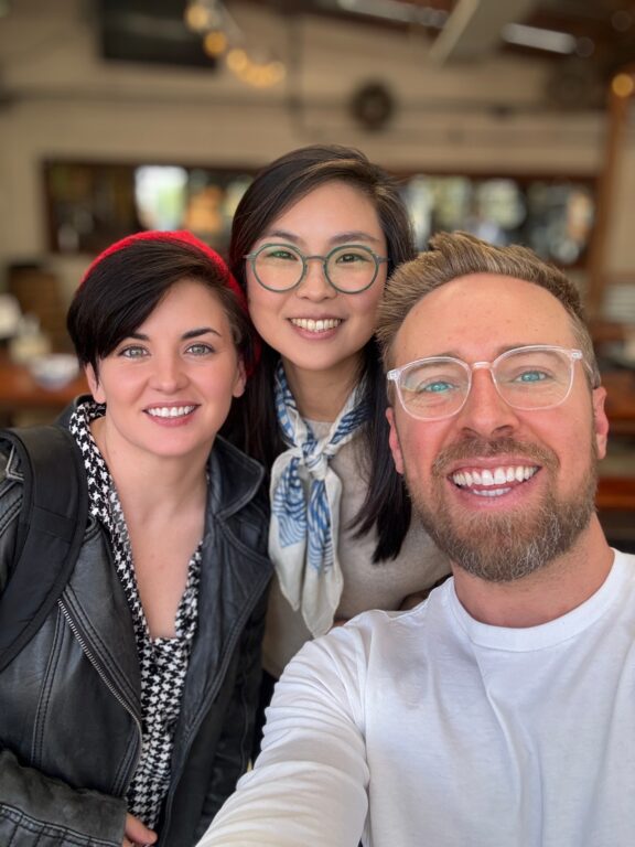 two women and one man smiling