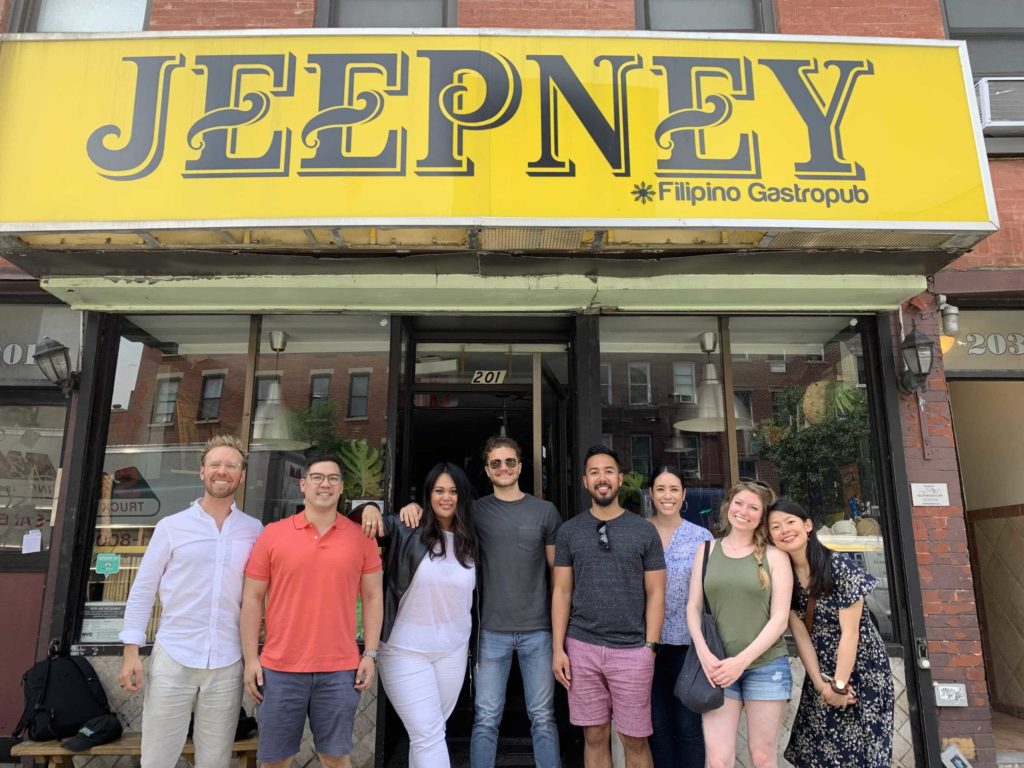 Group of people standing beneath the Jeepney restaurant