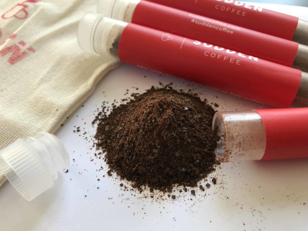 Beige pouch bag and instant coffee plus test tubes