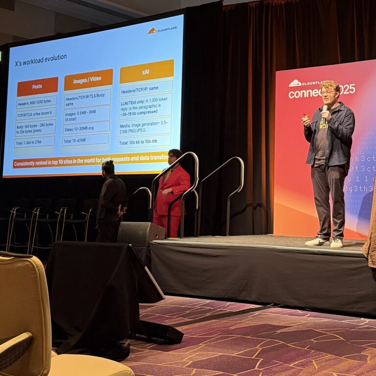 man on stage with a slide of info about X infrastructure Alex Krivit