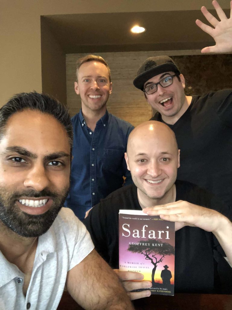 Four very attractive, diverse, handsome men with varying levels of hair discuss the book Safari by Goeffrey Kent