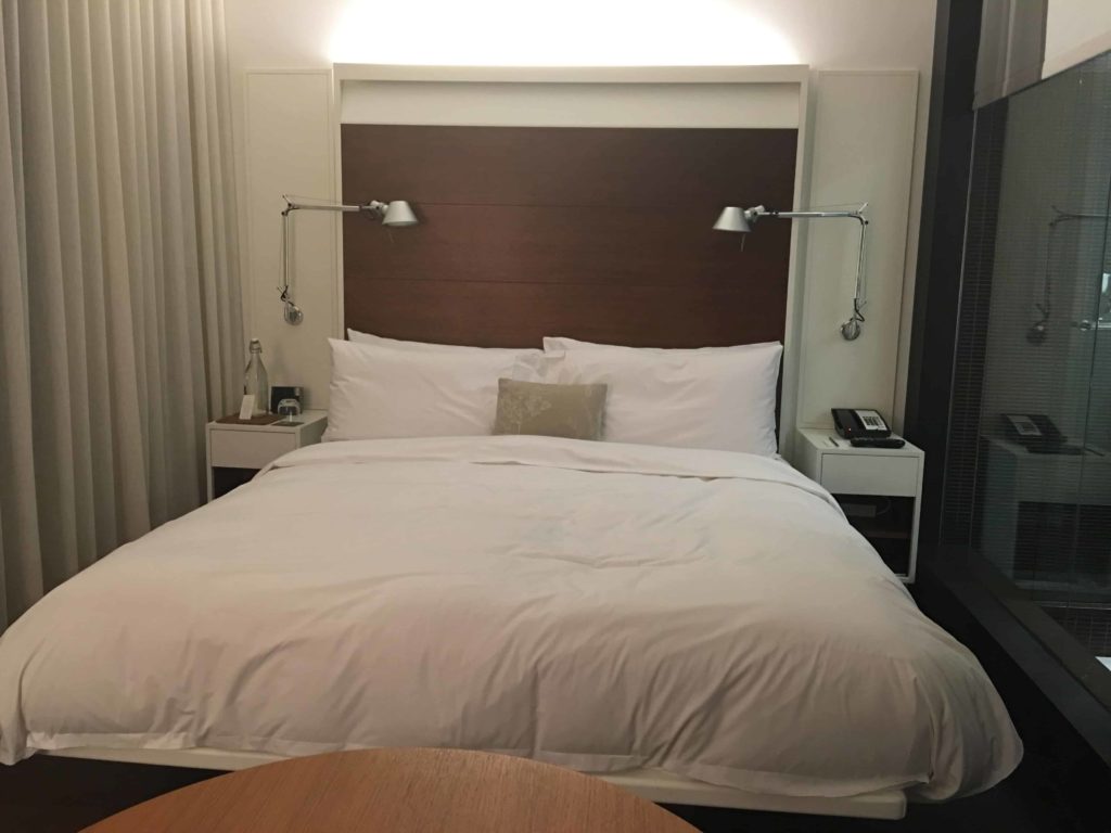 Bed, with overhead lights on