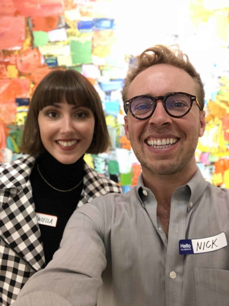 Two attractive people inside a London art gallery