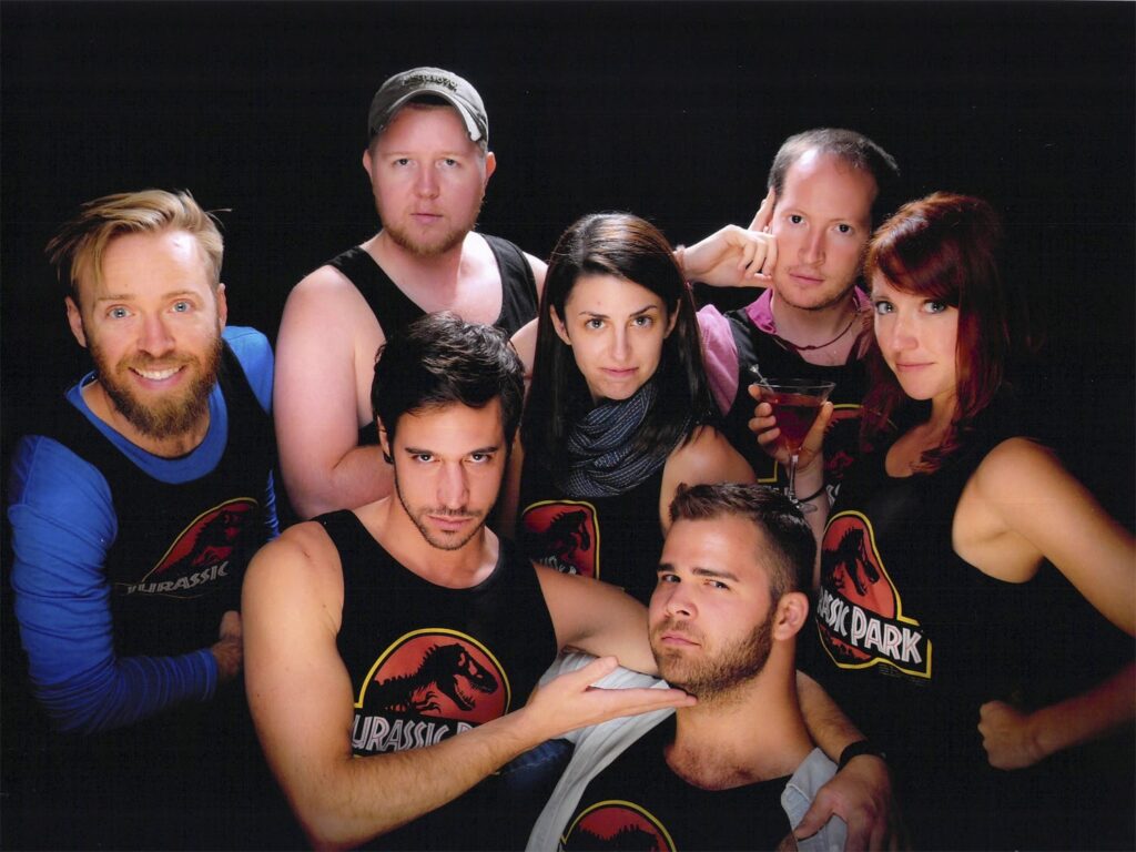 Seven people wearing Jurassic Park shirts for a Museum Hack company cruise