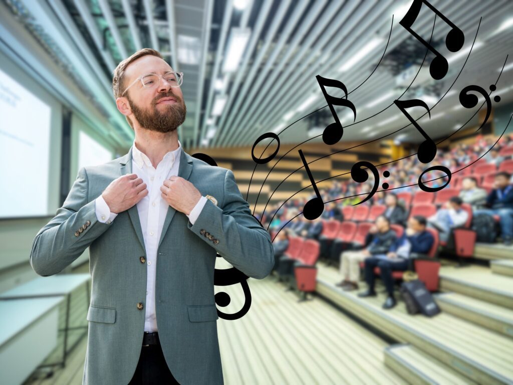 Man standing infront of crowd with music