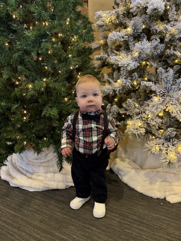 baby in front of a christmas tree