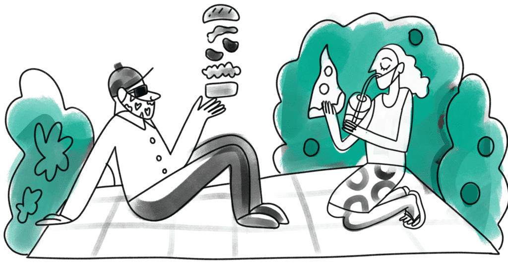 Two people sitting in a park, having a picnic