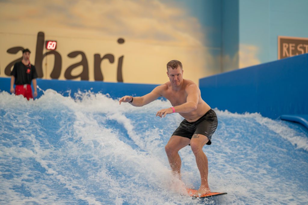 white man standing on the Flowrider surf machine, Sam Parr in Texas
