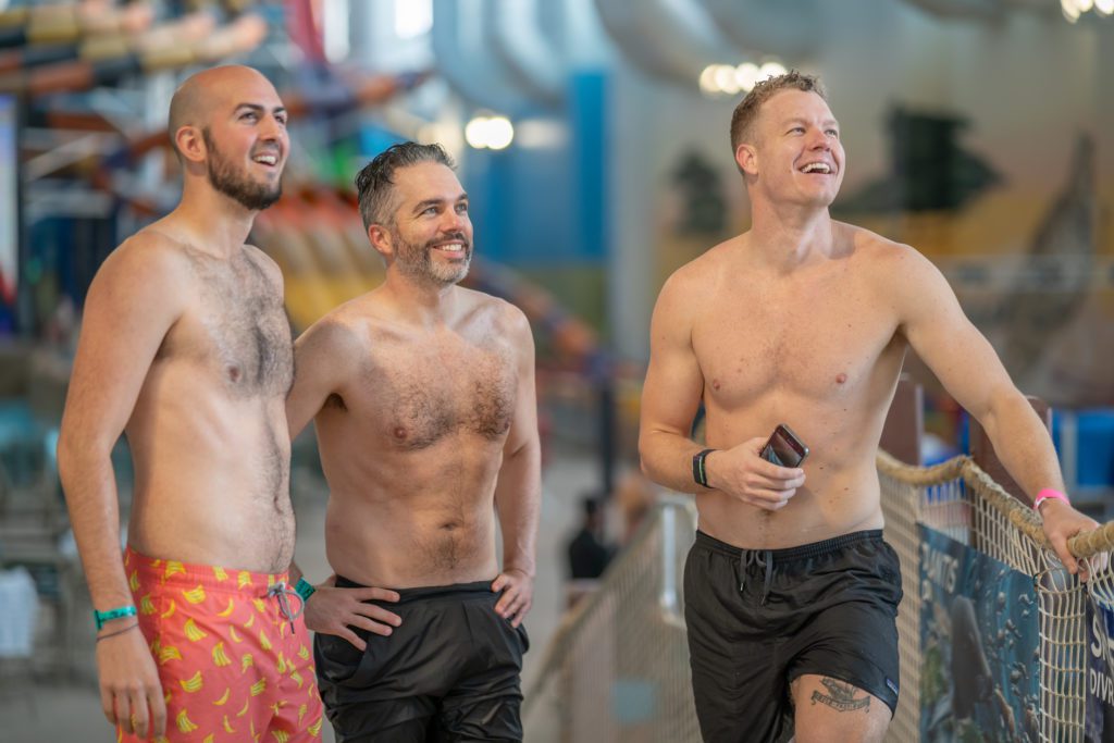 three men looking at something in the distance