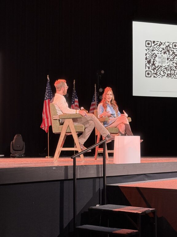 people sitting and talking on stage