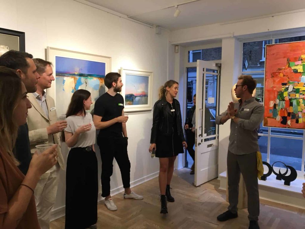 Friends in a gallery space standing around and me on the far right