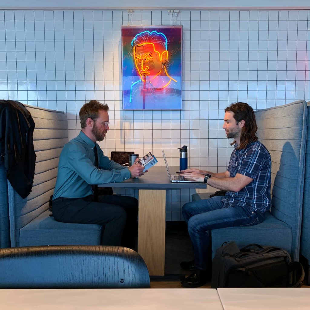 Nick Gray and Doug Barber co-working in Tokyo, sitting at a table
