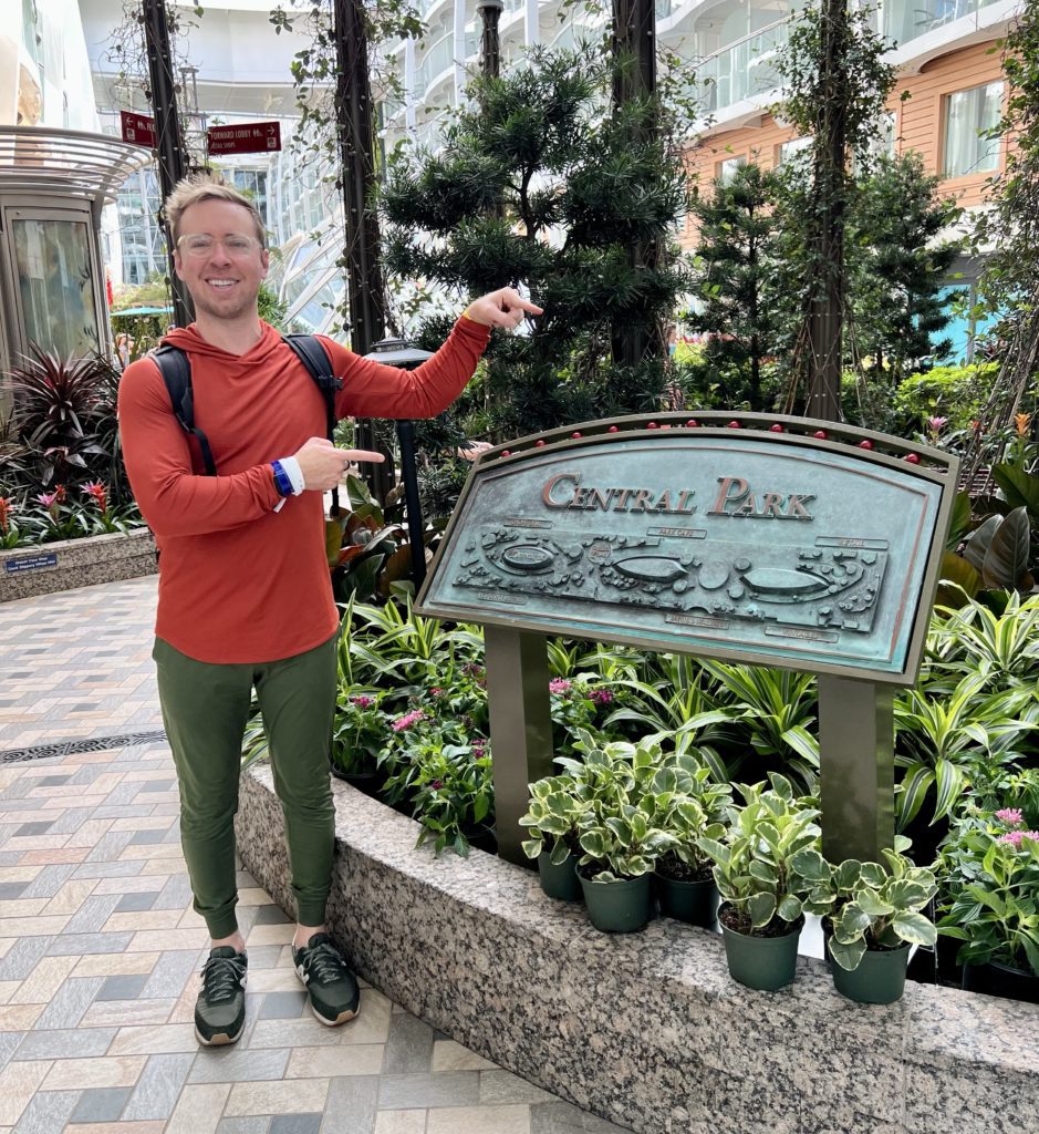 man standing inside Central Park aboard the Symphony of the Seas cruise ship