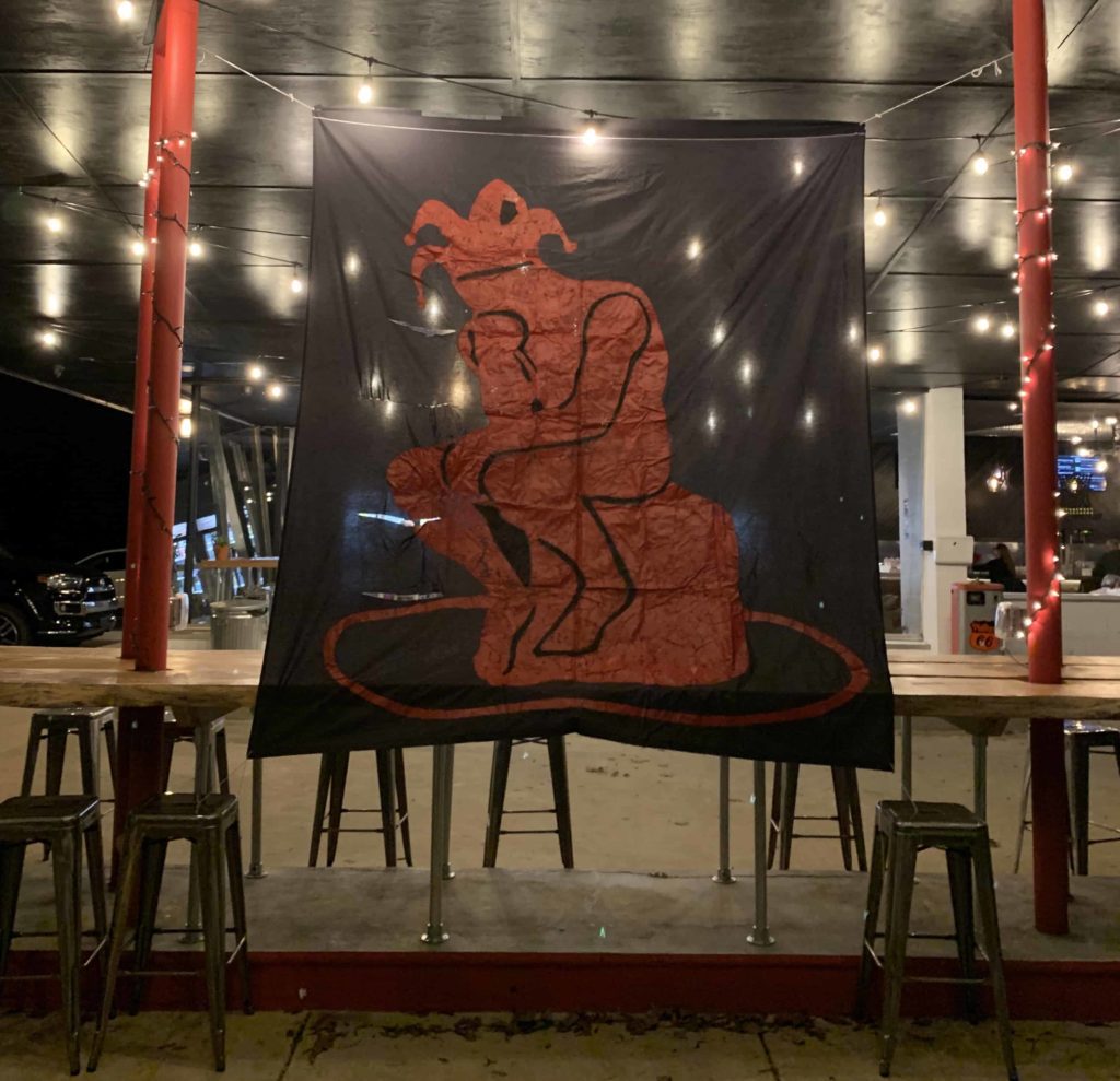 Large black banner with red joker guy