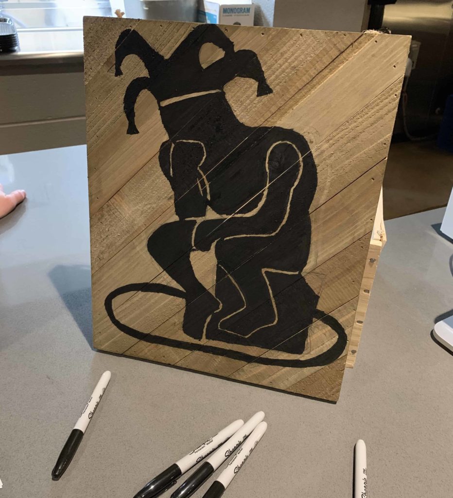 Table with a wooden block having the Lilting Banshees logo and markers