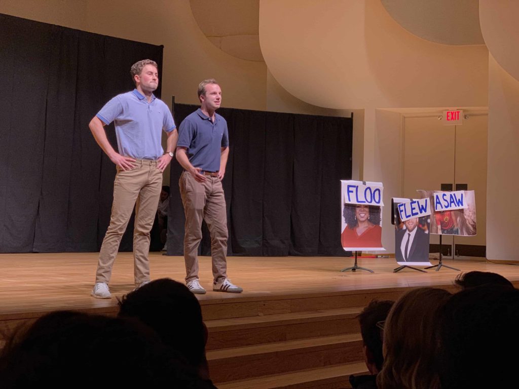 Two male members of the Lilting Banshees comedy troupe stand on stage at Wake Forest University