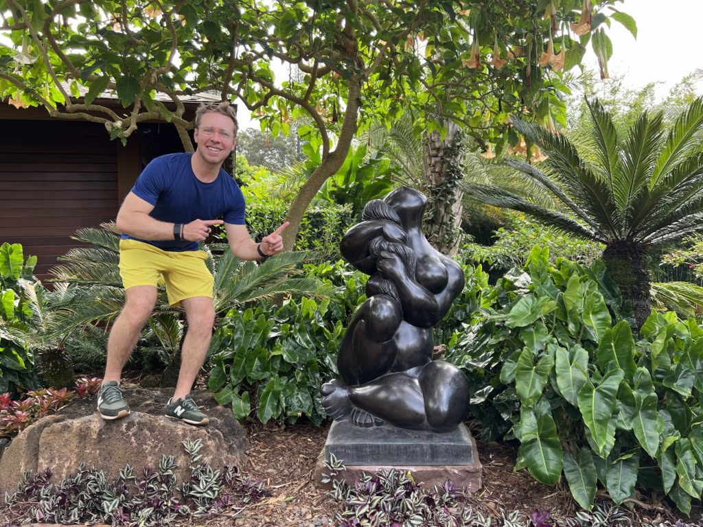 me standing next to a sculpture outside at Sensei Lanai