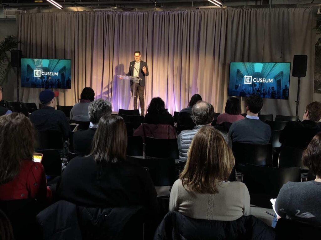 Brendan Ciecko speaking on stage at REMIX NYC