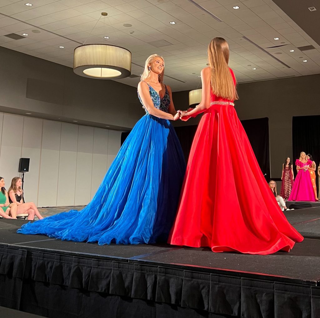 woman in blue evening gown and red gown