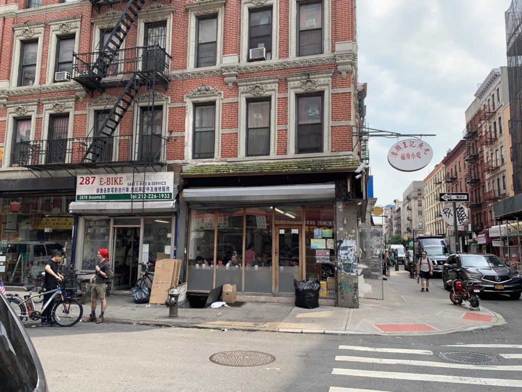 Corner street in New York City with the restaurant on the left side