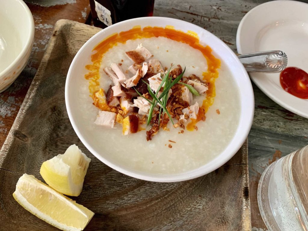 Bowl of rice, chicken on top, lemon slice in lower left