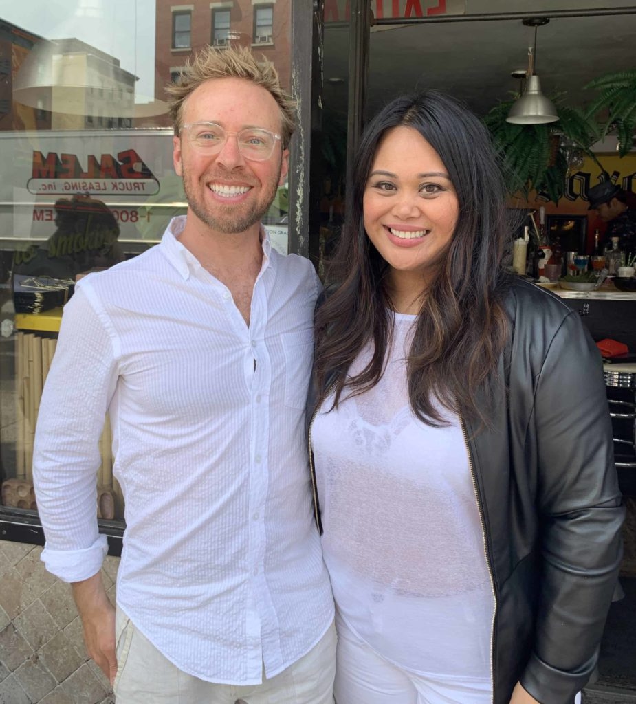 Nick Gray and Nicole Ponseca on the street outside of her restaurant Jeepney, both wearing white shirts