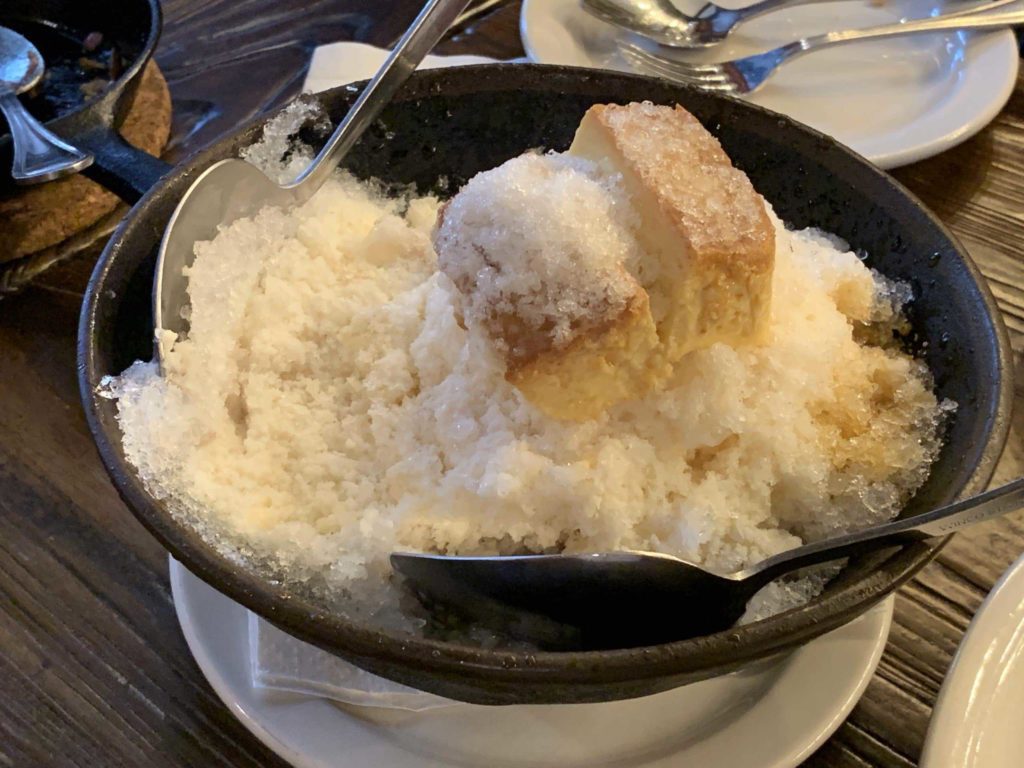 Black bowl and white sweets inside