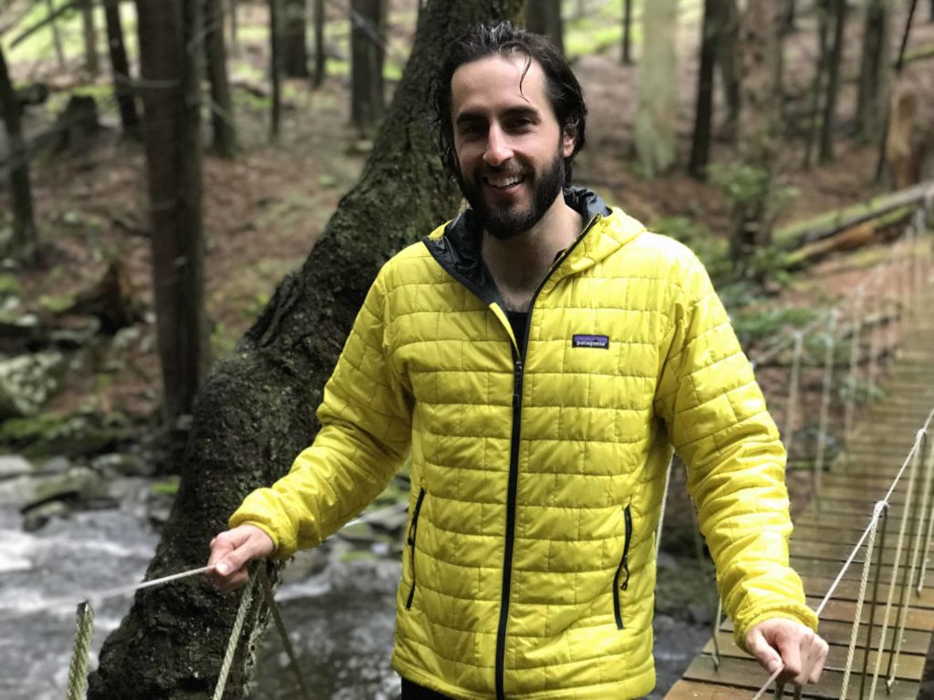 man on bridge wearing yellow jacket