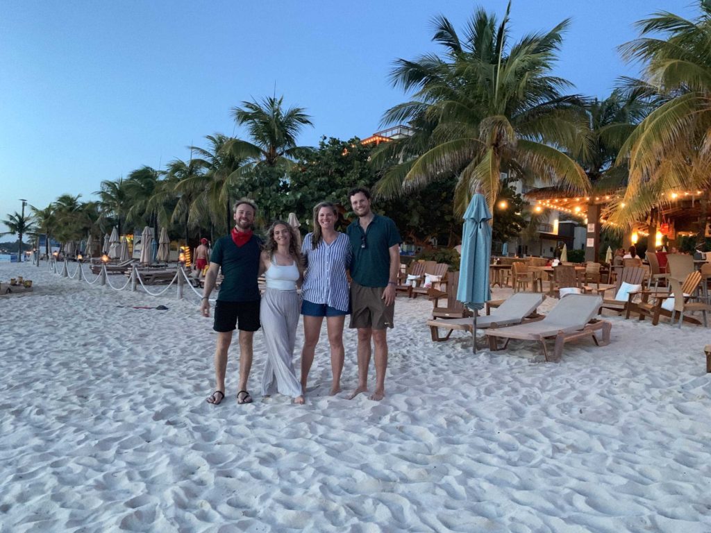 Four people on the beach in Roatan